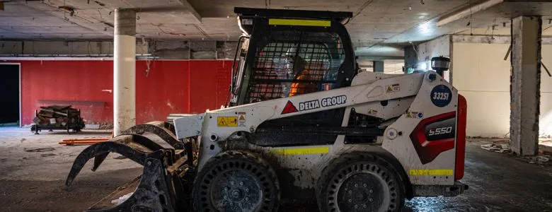 Delta Group skid steer on a Strum Media demolition shoot