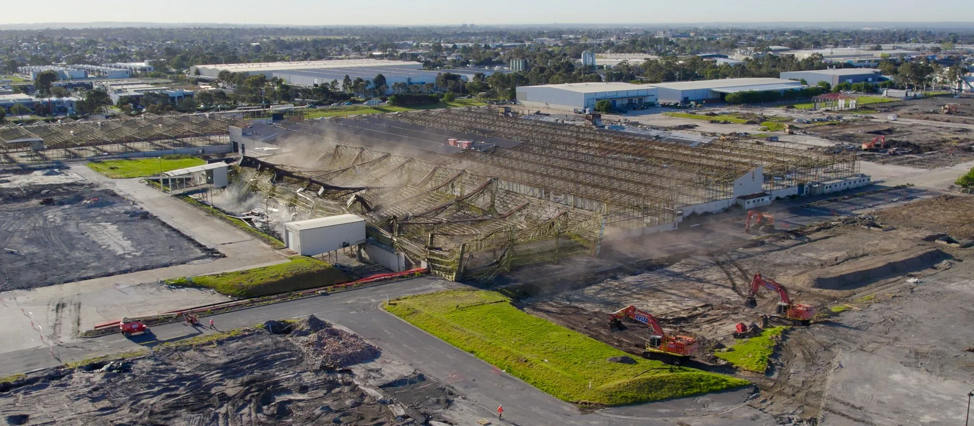 Excavator clearing debris at Clayton Business Park
