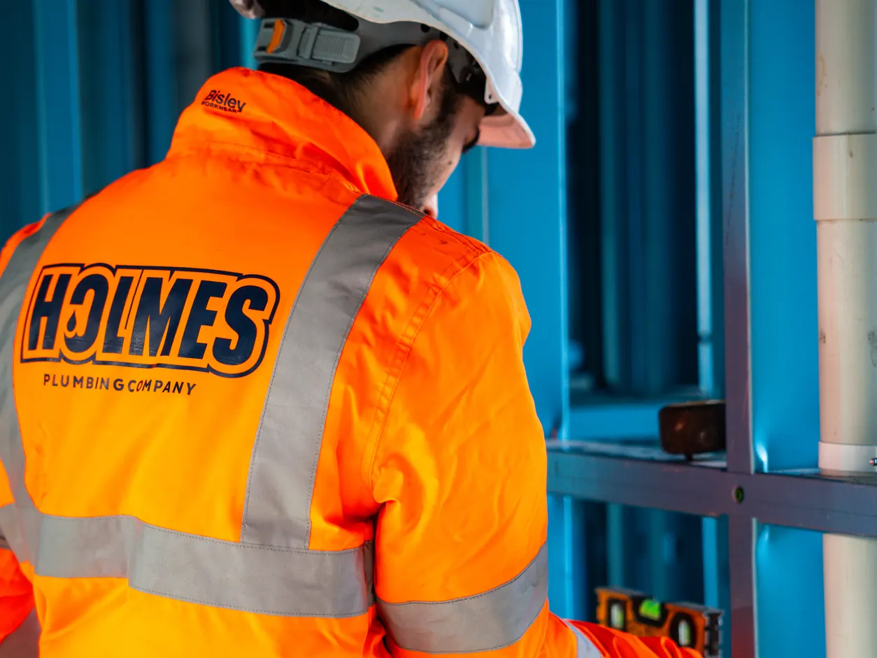 Holmes Plumbing Company plumber at work on site